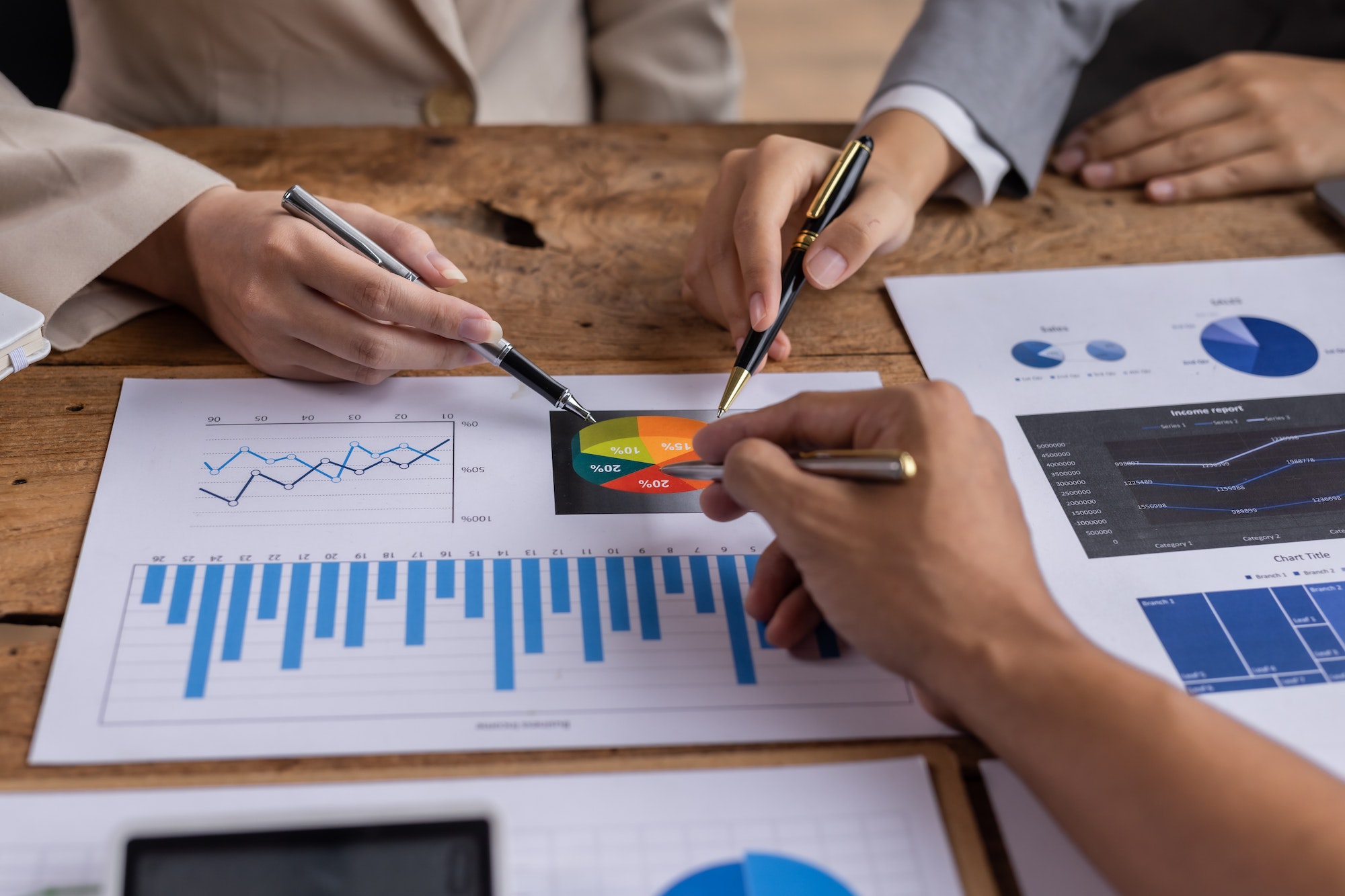 Financial analysts analyze business financial reports on digital tablet planning investment project
